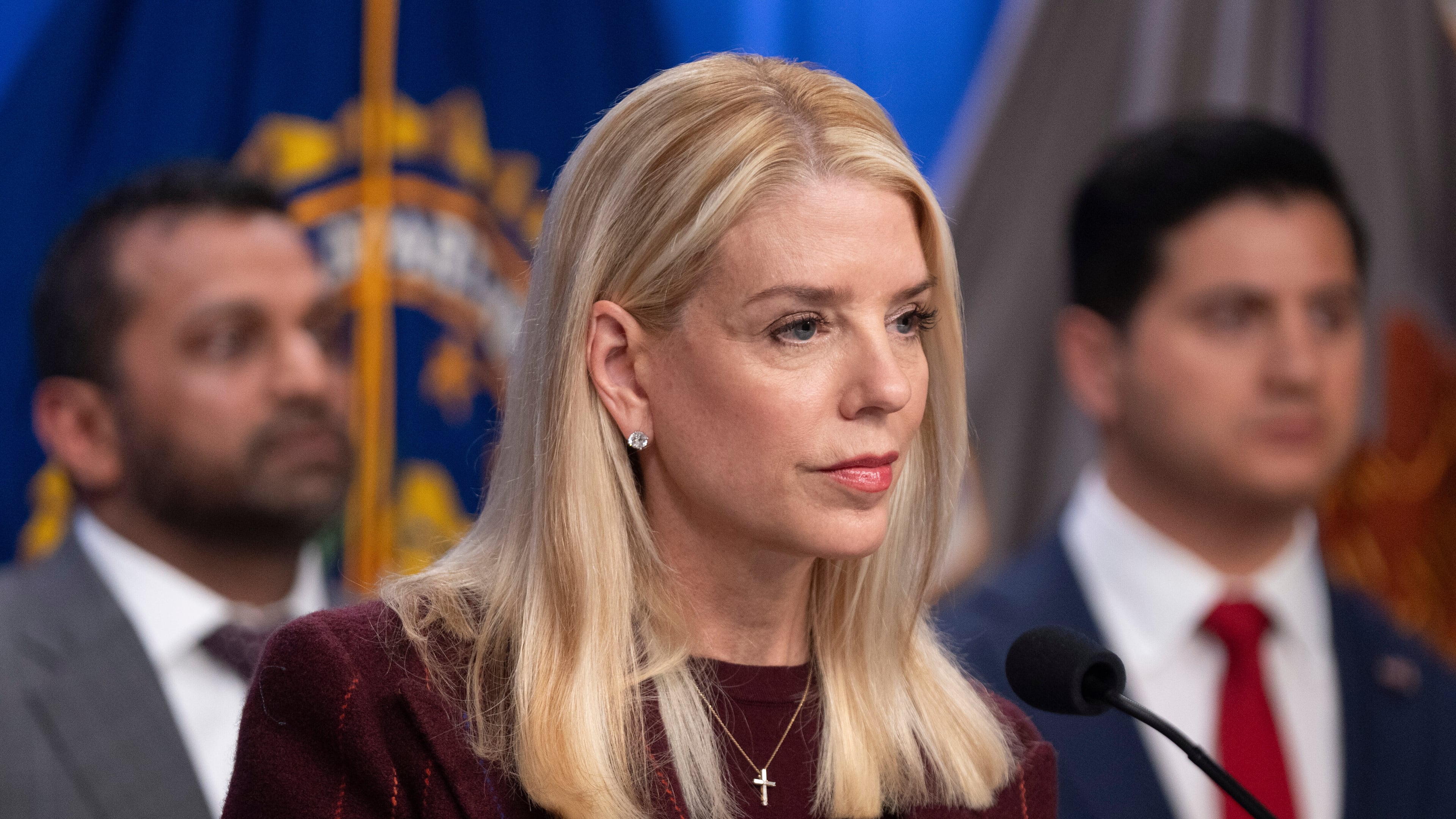 Attorney General Pam Bondi speaks with reporters as FBI Director Kash Patel, left, and Bill Essayli, acting U.S. Attorney for the Central District of California listen during a news conference at the Department of Justice, Wednesday, Nov. 19, 2025, in Washington. (AP Photo/Mark Schiefelbein)