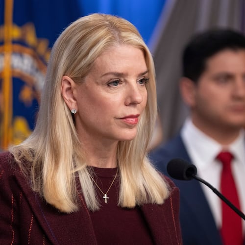 Attorney General Pam Bondi speaks with reporters as FBI Director Kash Patel, left, and Bill Essayli, acting U.S. Attorney for the Central District of California listen during a news conference at the Department of Justice, Wednesday, Nov. 19, 2025, in Washington. (AP Photo/Mark Schiefelbein)