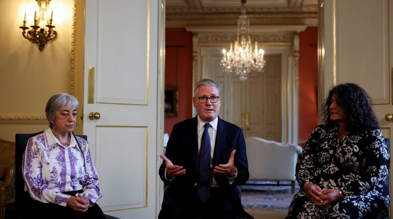 Britain's Prime Minister Keir Starmer, center, attends a meeting with campaigners to discuss historical forced adoption, at Downing Street, in London, Thursday July 2, 2026. (Isabel Infantes/Pool Photo via AP)