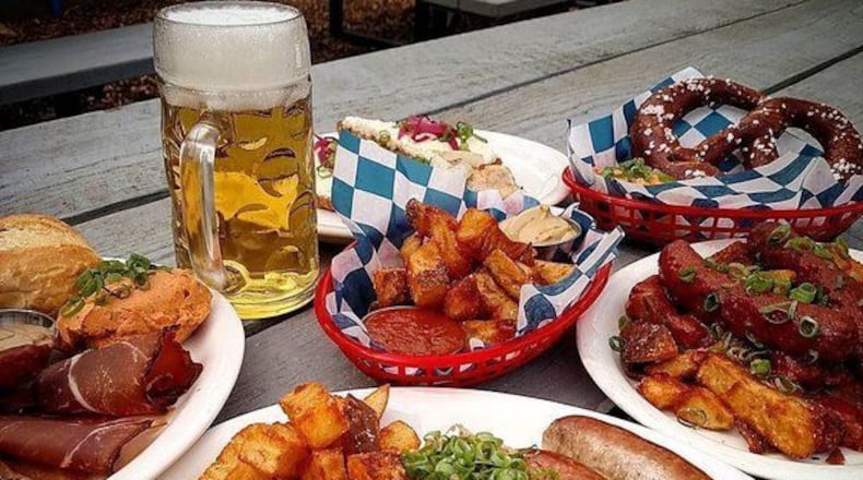 German beer garden snacks at Communion in Decatur, including Bavarian-style pretzels with hot mustard and grilled sausages with sauerkraut, mustard and beef fat-fried potatoes. CONTRIBUTED BY: Communion.