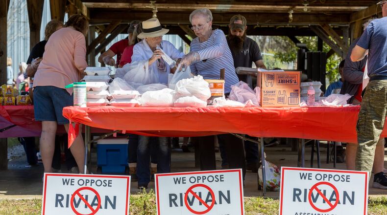 Andrea Wilson (Left) and Gail Wilson pack barbecue lunches during the Rivian Opposition Barbecue fundraiser in Rutledge Saturday, March 25, 2023.   (Steve Schaefer/steve.schaefer@ajc.com)