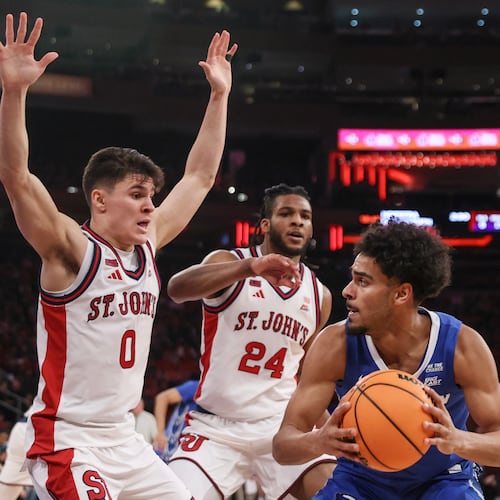 Creighton guard Nik Graves is defended by St. John's guard Dylan Darling (0) and forward Zuby Ejiofor (24) during the first half of an NCAA college basketball game, Saturday, Feb. 21, 2026, in New York. (AP Photo/Heather Khalifa)