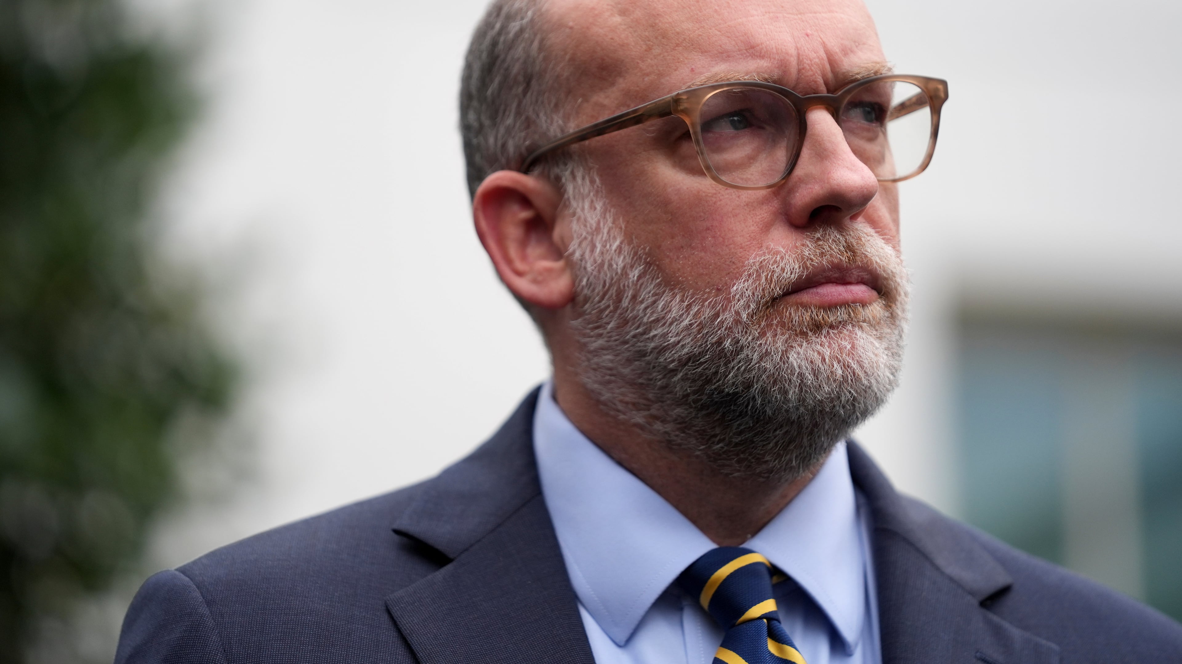 Russell Vought, Office of Management and Budget director, listens as he addresses members of the media outside the West Wing at the White House in Washington, Monday, Sept. 29, 2025, in Washington. (AP Photo/Evan Vucci)