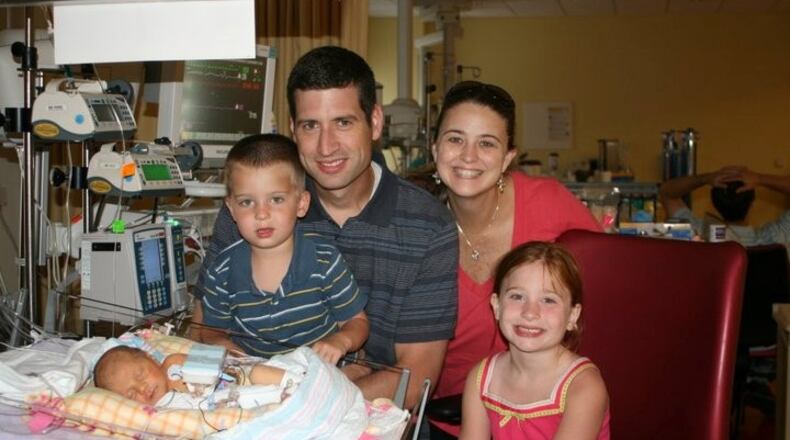 Mark, Amanda, Avery, and Ryan Koch visiting 5-day-old new baby sister Audrey at Children's Healthcare's Egleston Hospital. (Contributed)