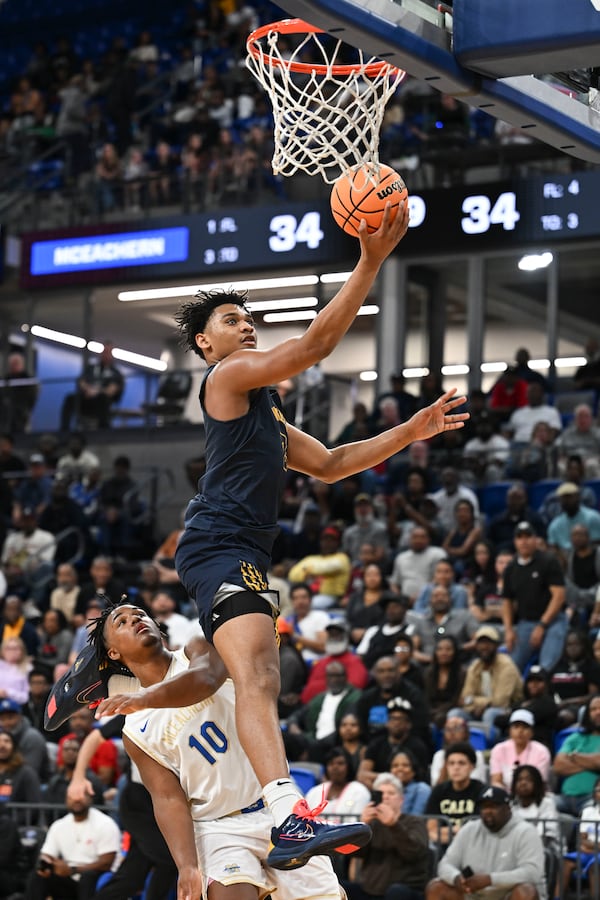 Wheeler's Colben Landrew (3) makes a layup over McEachern's Zachary Graves (10) during a GHSA Class 6A semifinal playoff game Saturday, March 7, 2026 at the Georgia State Convocation Center.(Daniel Varnado for the AJC)