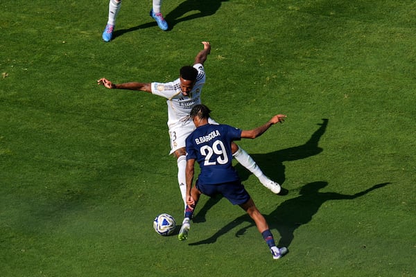 Paris Saint-Germain's Bradley Barcola (29) makes a pass to the front of the net past Real Madrid's Andriy Lunin (13) during the Club World Cup semifinal soccer match between PSG and Real Madrid in East Rutherford, N.J., Wednesday, July 9, 2025. (AP Photo/Pamela Smith)