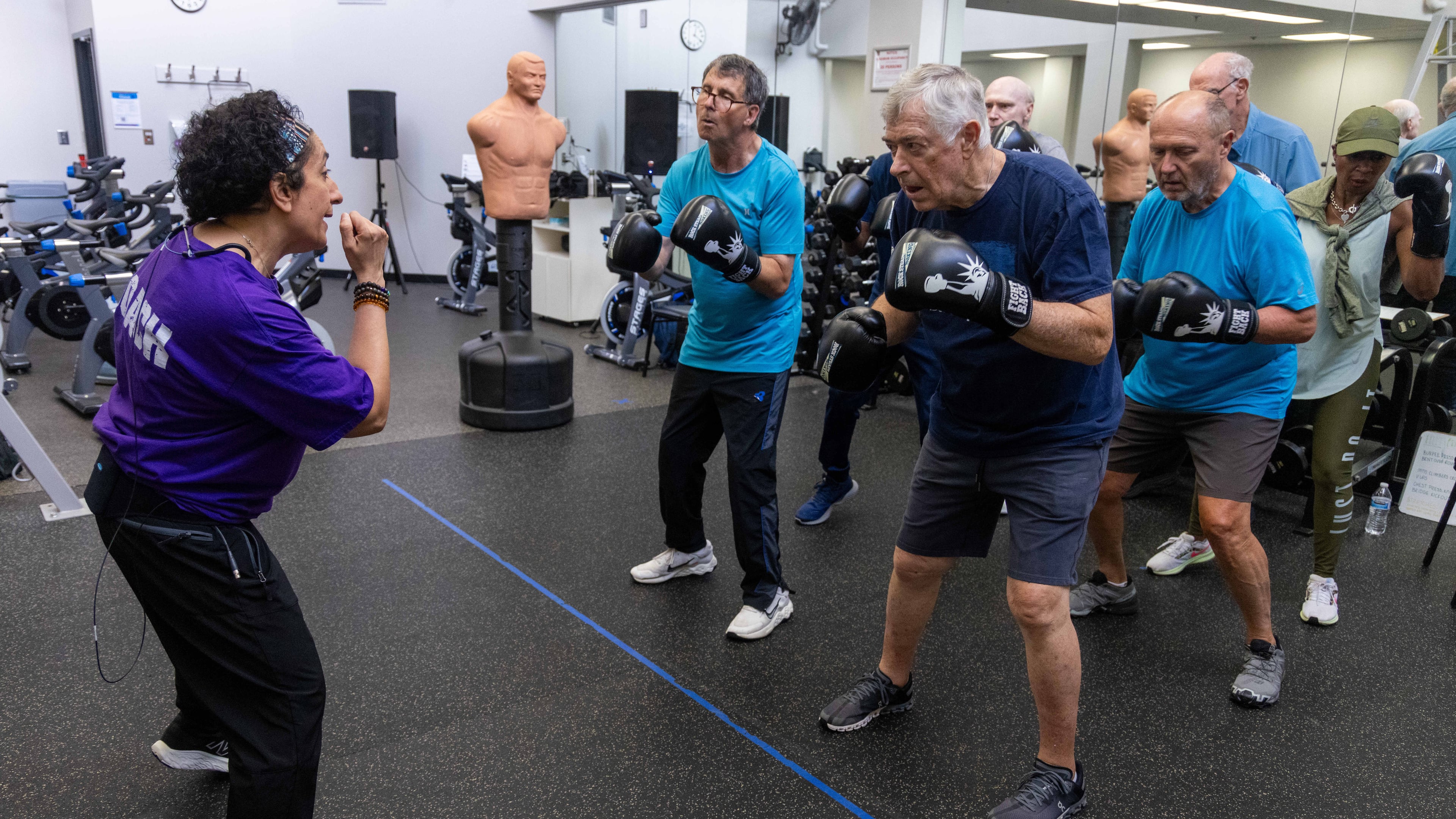 Nausheen Quraishy (left), a Rock Steady Boxing Instructor, teaches a strength training class at the Kennestone Health Place at Kennestone Hospital in Kennesaw, Georgia on July 24, 2024. (Courtesy of Phil Skinner/AJC)