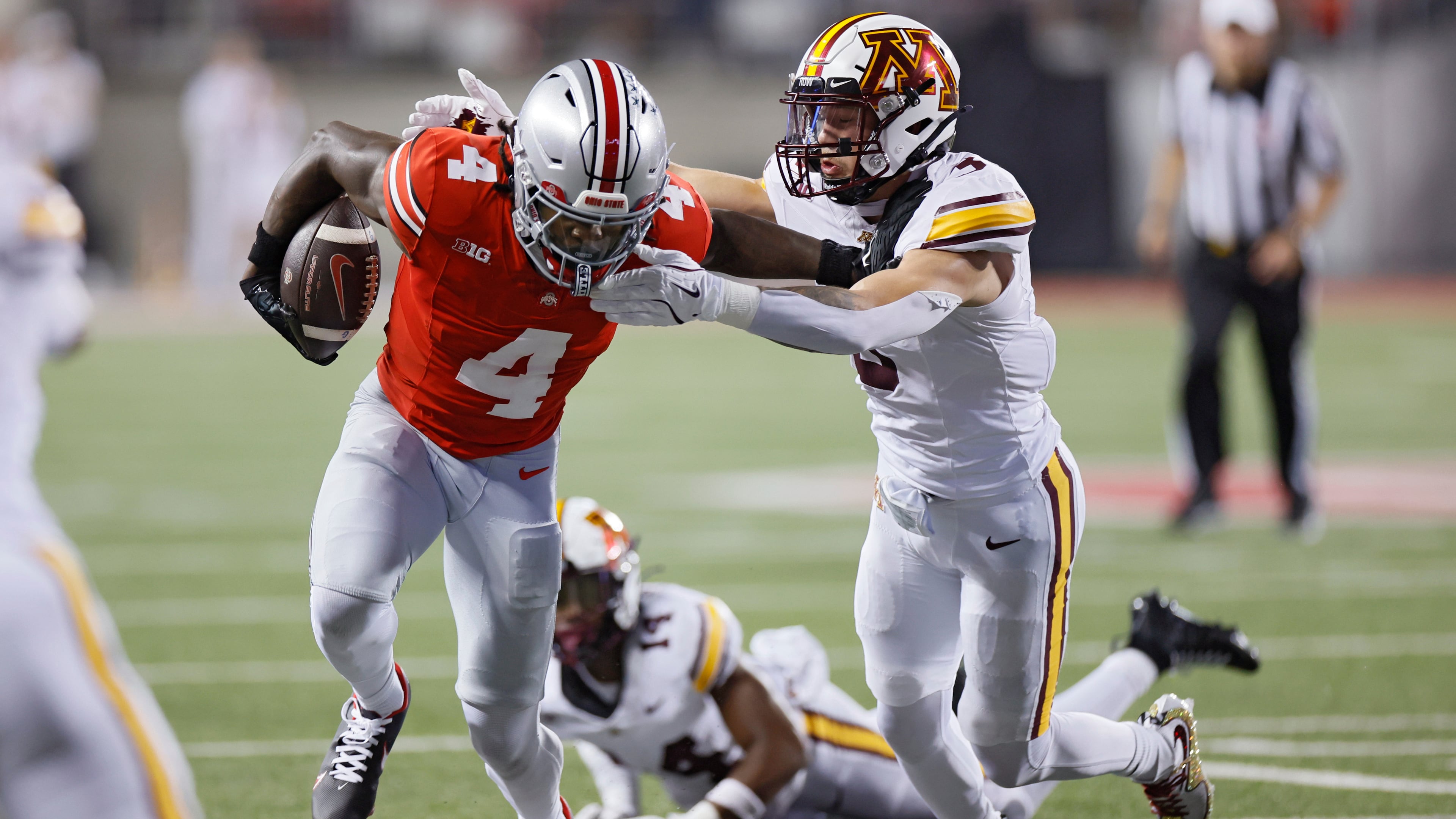 Ohio State receiver Jeremiah Smith, left, stiff arms Minnesota defensive back Koi Perich during the first half of an NCAA college football game Saturday, Oct. 4, 2025, in Columbus, Ohio. (AP Photo/Jay LaPrete)