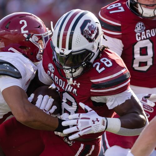 Alabama defensive back Zabien Brown (2) tackles South Carolina running back Matt Fuller (28) during the first half of an NCAA college football game, Saturday, Oct. 25, 2025, in Columbia, S.C. (AP Photo/Scott Kinser)