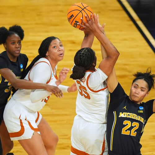 Texas forward Madison Booker (35) shoots on Michigan forward Kendall Dudley (22) during the first half in the Elite Eight of the NCAA college basketball tournament, Monday, March 30, 2026, in Fort Worth, Texas. (AP Photo/LM Otero)