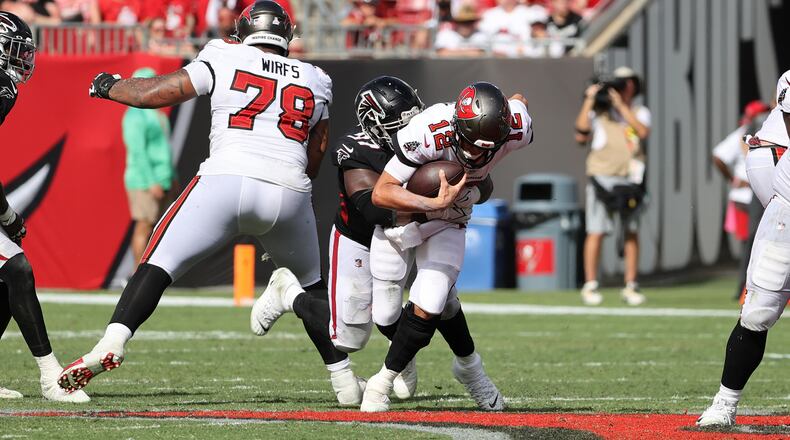 Atlanta Falcons defensive end Grady Jarrett (97) brings down Tampa Bay Buccaneers quarterback Tom Brady (12), resulting in a roughing-the-passer penalty, Sunday, Oct. 9, 2022, at Raymond James Stadium in Tampa, Florida. (Luis Santana/Tampa Bay Times/TNS)