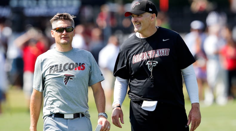 In this July 31, 2015, file photo, Falcons coach Dan Quinn, right, talks with general manager Thomas Dimitroff during an NFL football training camp in Flowery Branch, Ga. (AP Photo/John Bazemore, File)