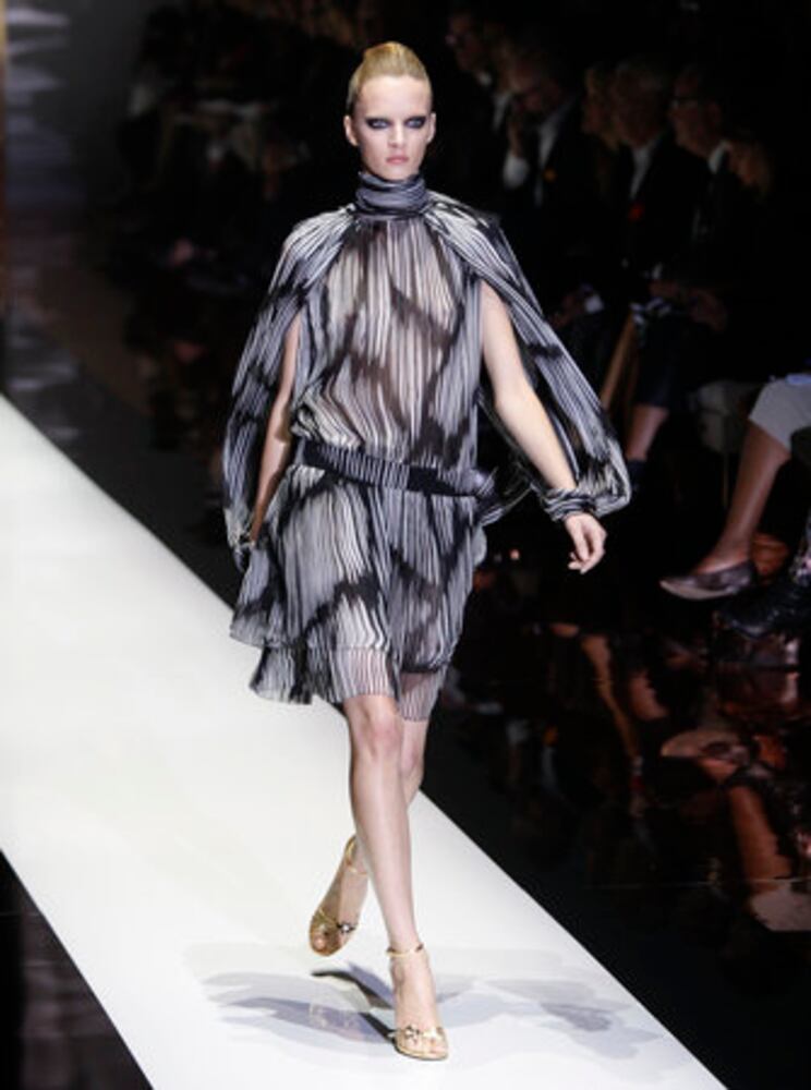 Models take the catwalk during Milan Fashion Week 2011