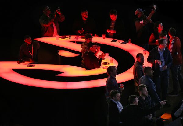 Basketball fans watch the game from the new open bar area at courtside in Philips Arena.    Curtis Compton/ccompton@ajc.com