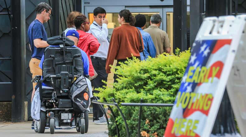 Early voters lined up before the doors opened Monday Oct. 15, 2018 at the Buckhead Library at 269 Buckhead Ave NE in Atlanta. Early voting locations opened across Georgia starting Monday. JOHN SPINK/JSPINK@AJC.COM