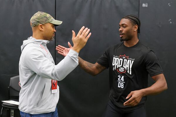 Georgia safety Malaki Starks (right) greets Atlanta Falcons general manager Terry Fontenot during the school’s NFL Pro Day at the University of Georgia Indoor Practice Facility, March, 12, 2025, in Athens. (Jason Getz / AJC)