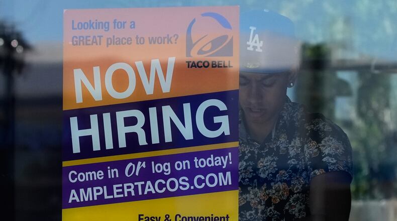 A hiring sign is displayed at a restaurant in Niles, Ill., Thursday, May 14, 2026. (AP Photo/Nam Y. Huh)