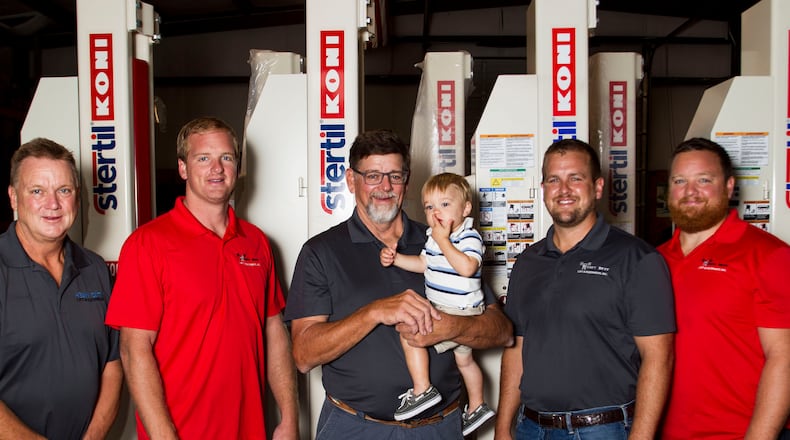 His Duluth-based heavy lift company is a family business for former Falcon Jeff Merrow (center). He is flanked, from far left, by his brother David Merrow, sons Jeffrey, Ian and Thor.  He's holding grandson Colin.
