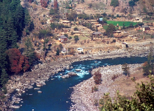 FILE - A Pakistan administered Kashmir village is seen from the Indian border along the Kishan Ganga river on the dividing line of the Line of Control which divides India and Pakistan in the Keran Sector, some 166kms (101 miles) northwest of Srinagar, India Monday, Nov. 6, 2000. (AP Photo/Aijaz Rahi, File)