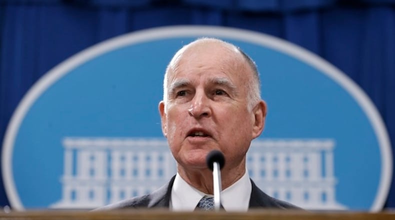 FILE - In this Jan. 10, 2017, file photo, California Gov. Jerry Brown discusses his 2017-2018 state budget plan he released at a news conference in Sacramento, Calif. Gov. Jerry Brown likened President Donald Trump to a strongman whose goal of walling off the U.S.-Mexico border conjures other infamous barriers from the past. Brown said during an interview broadcast Sunday, March 26, 2017, on NBC's "Meet the Press" that the president's promised border wall is "ominous" and reminiscent of the Berlin Wall. (AP Photo/Rich Pedroncelli, File)