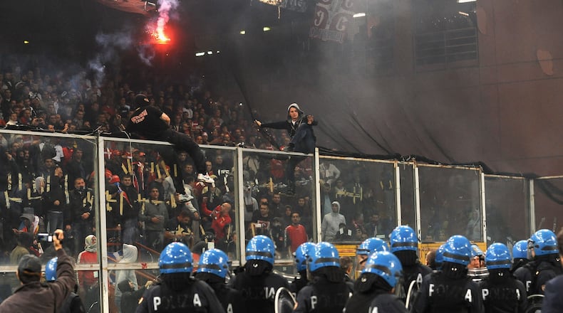 Police in riot gear confront Serbia fans during a match between Italy and Serbia in Genoa, Italy. (Valerio Pennicino/Getty Images)