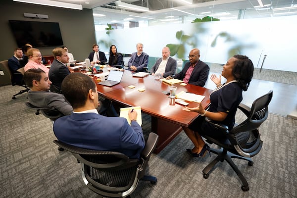 Kimberly Sheridan, right, leads an attorney meeting at the Atlanta office of national law firm Gordon Rees Scully Mansukhani. (Miguel Martinez/AJC)