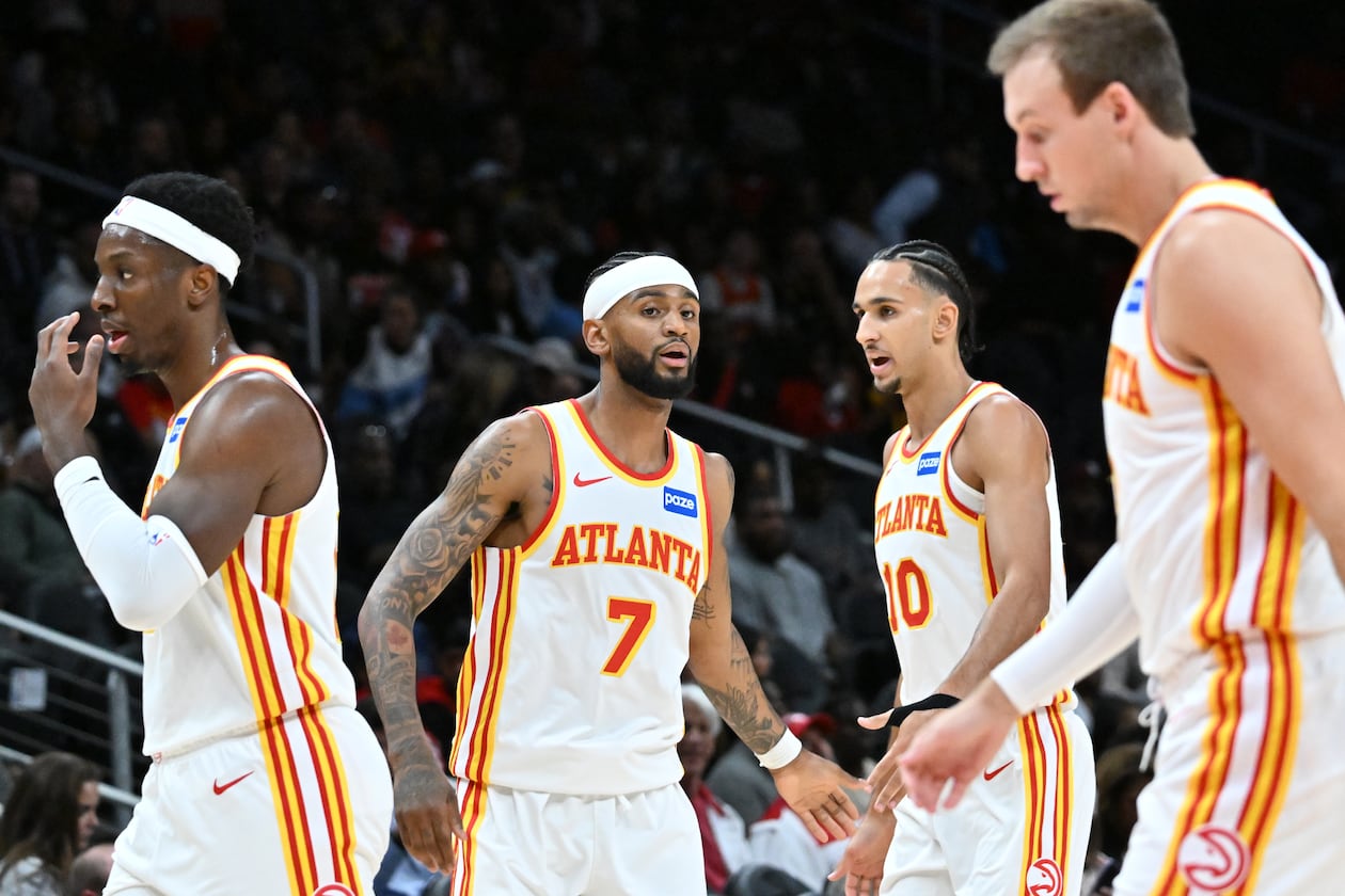 Atlanta Hawks forward/center Onyeka Okongwu (from left) guard Nickeil Alexander-Walker (7), forward Zaccharie Risacher (10) and guard Luke Kennard (3) react during the first half in a preseason NBA basketball game at State Farm Arena, Thursday, October 16, 2025, in Atlanta. Houston Rockets won 133-115 over the Hawks. (Hyosub Shin/AJC)