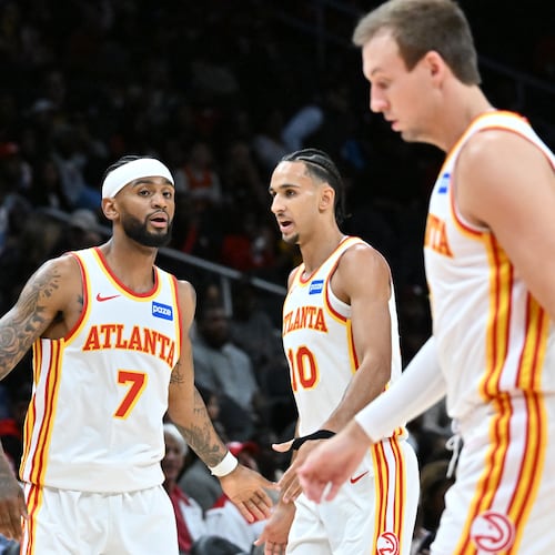 Atlanta Hawks forward/center Onyeka Okongwu (from left) guard Nickeil Alexander-Walker (7), forward Zaccharie Risacher (10) and guard Luke Kennard (3) react during the first half in a preseason NBA basketball game at State Farm Arena, Thursday, October 16, 2025, in Atlanta. Houston Rockets won 133-115 over the Hawks. (Hyosub Shin/AJC)
