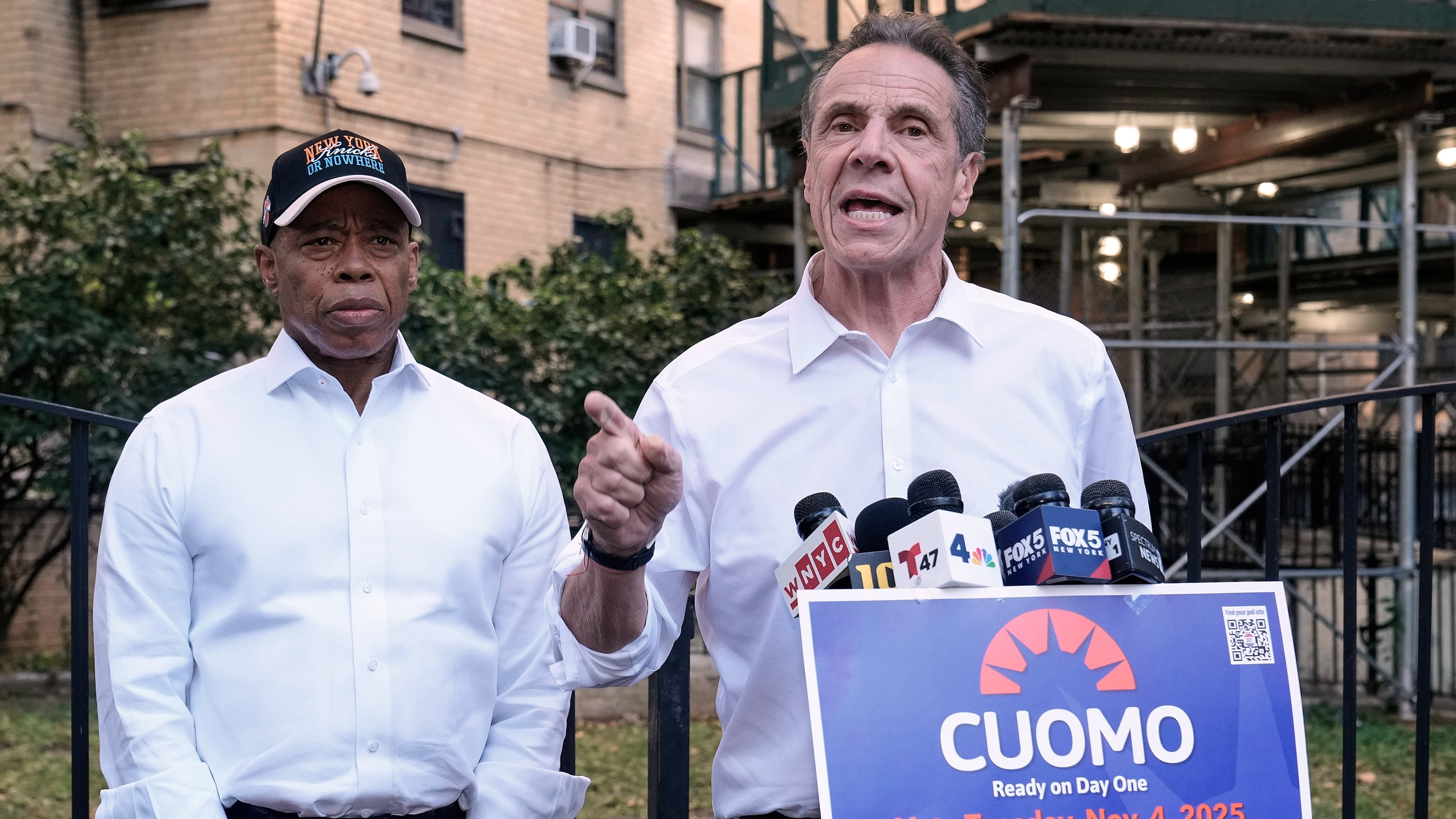 New York Mayor Eric Adams, left, and Democrat mayoral candidate Andrew Cuomo appear at a campaign event outside the George Washington Carver Houses, in New York, Thursday, Oct. 23, 2025. (AP Photo/Richard Drew)