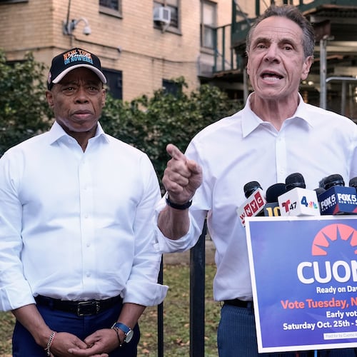 New York Mayor Eric Adams, left, and Democrat mayoral candidate Andrew Cuomo appear at a campaign event outside the George Washington Carver Houses, in New York, Thursday, Oct. 23, 2025. (AP Photo/Richard Drew)