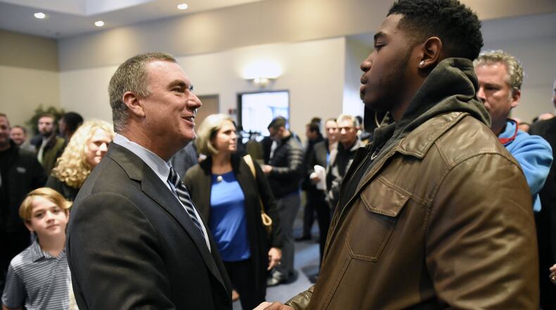 Shawn Elliott shakes hands with Georgia State quarterback Emiere Scaife before a news conference where he was introduced as the head football coach for Georgia State in Atlanta, Georgia, on Friday, December 9, 2016. (DAVID BARNES / DAVID.BARNES@AJC.COM)