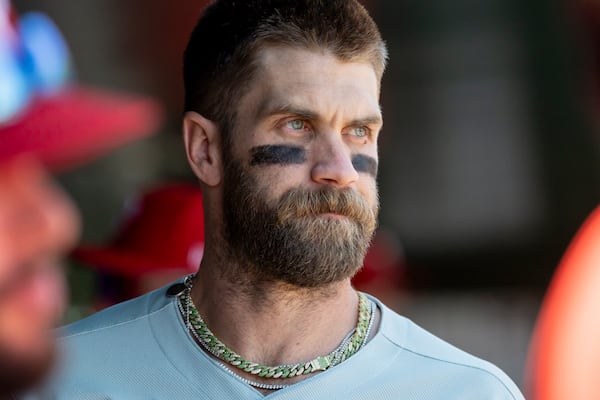 Philadelphia Phillies first baseman Bryce Harper gets ready in the dugout before a baseball game against the Athletics, Sunday, May 25, 2025, in West Sacramento, Calif. (AP Photo/Sara Nevis)