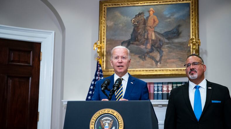 President Joe Biden speaks about student loan forgiveness, while joined by Education Secretary Miguel Cardona, in the Roosevelt Room of the White House, Washington, on Aug. 24, 2022. (Al Drago/The New York Times)