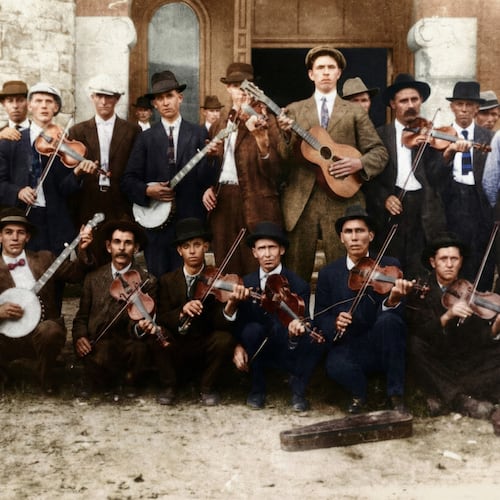 Known as “Seven-Foot Dilly,” the tall man in this colorized photo with the guitar was Atlanta fireman John Dilleshaw. Recordings of Dilleshaw will be accessible to the public on the Discography of American Historical Recordings through a partnership between Atlanta's Dust-to-Digital label and the University of California, Santa Barbara. (Courtesy of Dust-to-Digital)