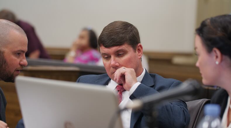 Griffin Judicial Circuit District Attorney Benjamin Coker (center), with GBI Special Agent Jared Coleman (right) and Chief Assistant District Attorney Marie Broder (left). (POOL PHOTO BY MAX PELTZ)