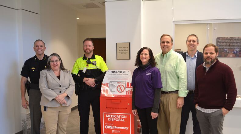 Johns Creek Mayor John Bradberry, Mayor Pro Tem Chris Coughlin, Johns Creek Police Department Chief Mark Mitchell, police officers, city staff, and One Johns Creek Coalition members gathered recently to mark the placement of the Drug-Drop-Box at city hall. (Courtesy City of Johns Creek)