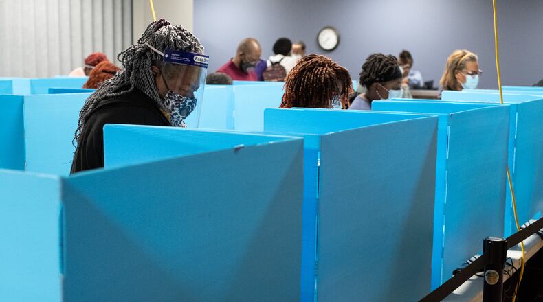 201012-Decatur-Janet Andrews, of Decatur, makes her selections during early voting Monday morning October 12, 2020 at the DeKalb County elections office in Decatur. Andrews said she wanted to vote in person to make sure the changes she wanted would happen. Ben Gray for the Atlanta Journal-Constitution