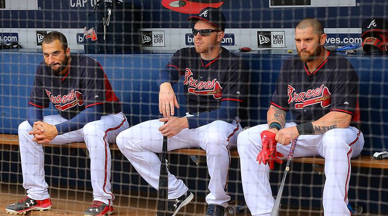 Braves Nick Markakis (from left), Freddie Freeman and Jonny Gomes sit in the dugout during batting practice before taking on the Nationals in the second game of a three-game series on Tuesday, April 28, 2015, in Atlanta.