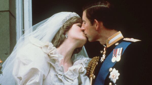 FILE - In this July 29, 1981 file photo, Britain's Prince Charles kisses his bride, the former Diana Spencer, on the balcony of Buckingham Palace in London after their wedding. Thirty-six years after Lady Diana Spencer married Prince Charles, The Associated Press has restored original footage from the wedding and is making it available to the public on YouTube. The 25 minutes of footage comes from the archive of British Movietone, which AP acquired in 2016. (AP Photo, File)