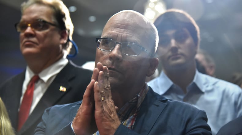 A Brian Kemp supporter on edge at Tuesday’s watch party in Athens. HYOSUB SHIN / HSHIN@AJC.COM