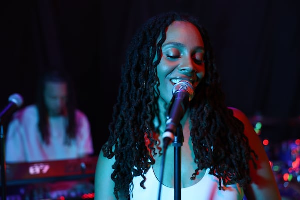 Singer, songwriter and actress Jade Novah sings as her husband and creative partner Devin Johnson plays piano at their home studio in metro Atlanta. (Arvin Temkar/AJC)