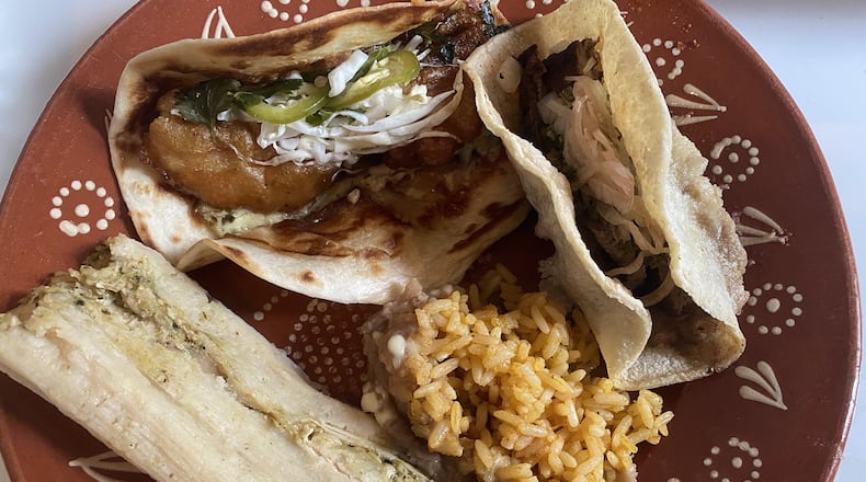 This takeout order from Good Word, plated at home, includes a carne asada taco, pollo verde tamale, Mexican rice and beans. CONTRIBUTED BY BOB TOWNSEND