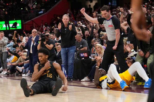 Cleveland Cavaliers forward De'Andre Hunter, left, celebrates after hitting a three-point shot and drawing a foul on Indiana Pacers forward Pascal Siakam, right, during the second half in Game 5 of an Eastern Conference semifinal NBA basketball playoff Tuesday, May 13, 2025, in Cleveland. (AP Photo/Sue Ogrocki)