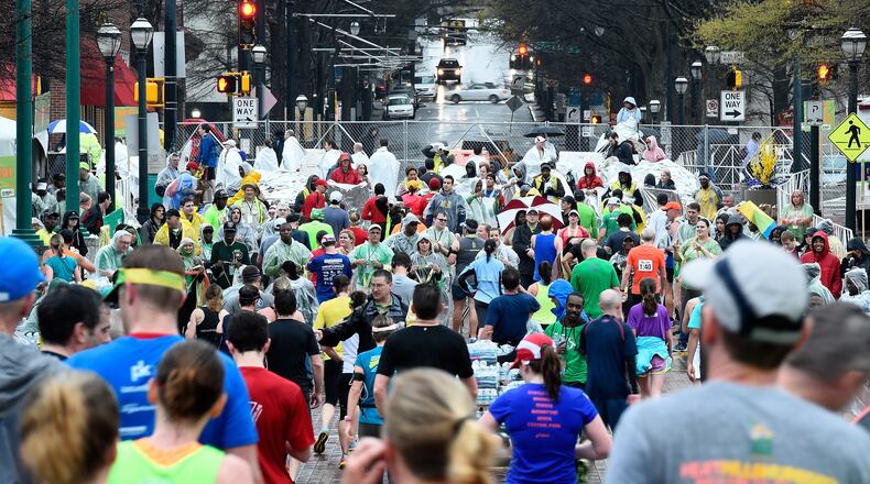 Despite a steady rain, runners from 46 states and 22 countries participate in the Publix Georgia Marathon & Half Marathon, Luckie 5K and Wheelchair Half Marathon on Sunday, March 22, 2015, in Atlanta. David Tulis / AJC Special