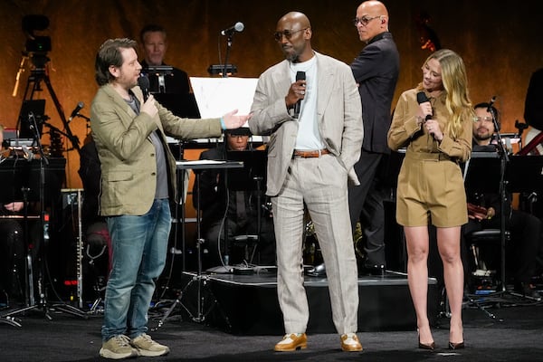 Gareth Edwards, from left, director of the upcoming film "Jurassic World Rebirth," Mahershala Ali, left, and Scarlett Johansson, cast members of the upcoming film "Jurassic World Rebirth," appear onstage during the Universal Pictures and Focus Features presentation at CinemaCon on Wednesday, April 2, 2025, at Caesars Palace in Las Vegas. (AP Photo/Chris Pizzello)