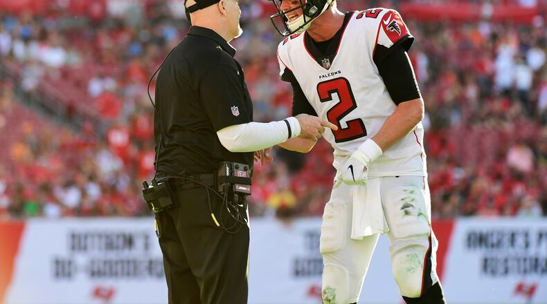 Falcons head coach Dan Quinn and quaterback Matt Ryan discuss the next play during the final minute of a 34-32 win over Tampa Bay Buccaneers Dec. 30, 2018, at Raymond James Stadium in Tampa, Fla.