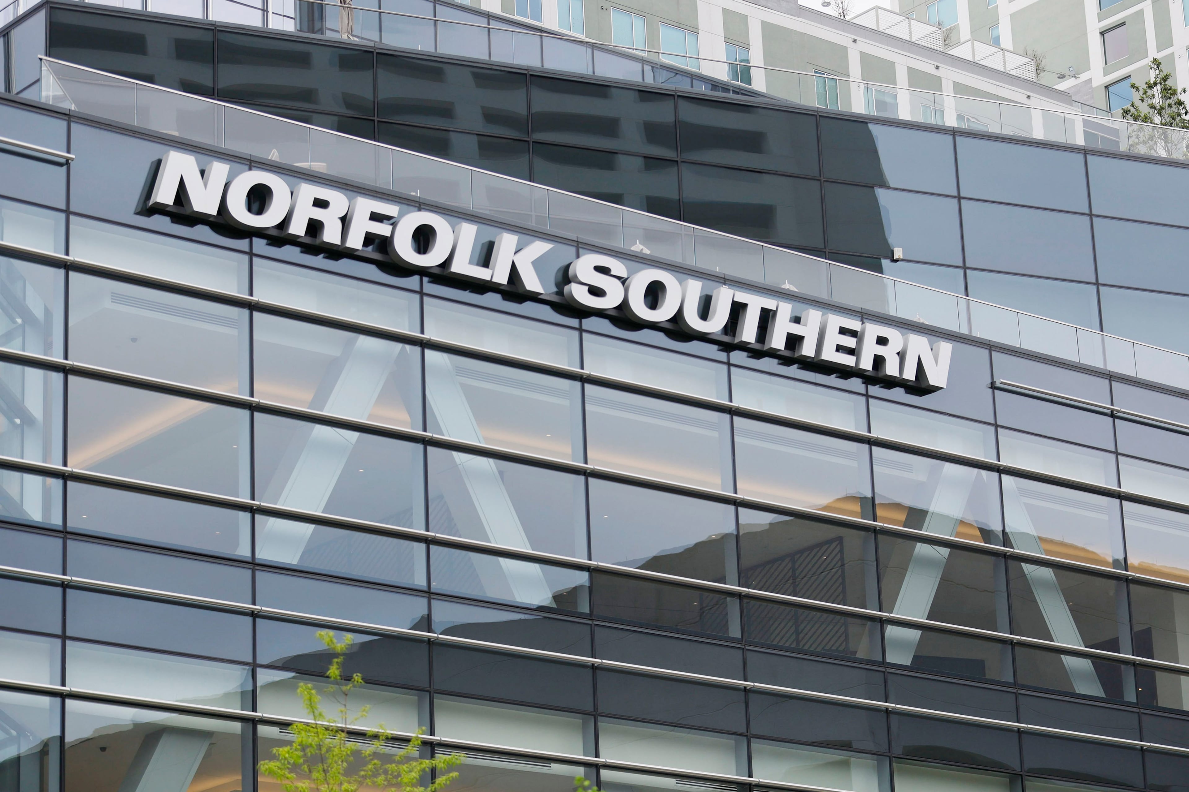 The Norfolk Southern logo is prominently displayed on the company's headquarters in Atlanta. The potential downsizing to come has neighborhood stakeholders holding their breath. (Miguel Martinez/AJC 2023)
