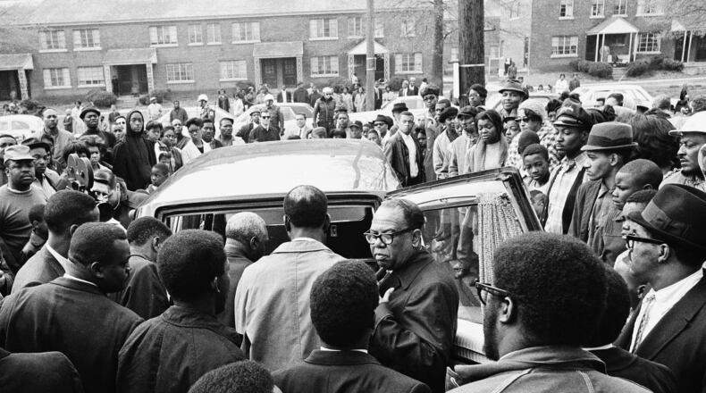 After a brief memorial service in Memphis on April 5, 1968, people stand around the Cadillac hearse that would carry the body of Martin Luther King Jr. to the airport. (AP photo)
