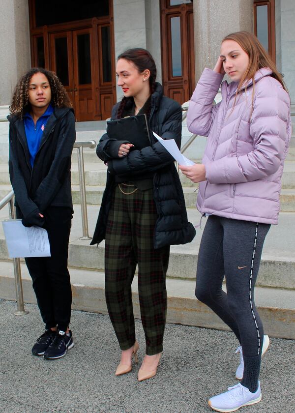 High school track athletes Alanna Smith, left, Selina Soule, center, and and Chelsea Mitchell prepare to speak at a news conference. The three girls have filed a federal lawsuit to block a state policy that allows transgender athletes to compete in girls sports.