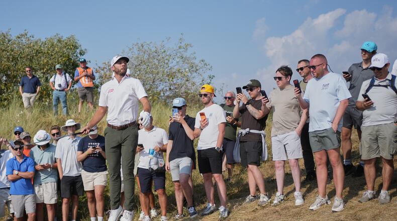 Sam Burns jumps up to try and see the pin on the 9th hole during the third day of the British Open Golf championships at Royal Birkdale golf club, in Southport, England, Saturday, July 18, 2026. (AP Photo/Jon Super)